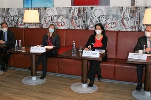 Vier Menschen sitzen an einem Tisch.